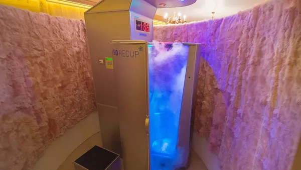 Cryotherapy cabin with wool walls and purple light, displaying a temperature of -166 degrees